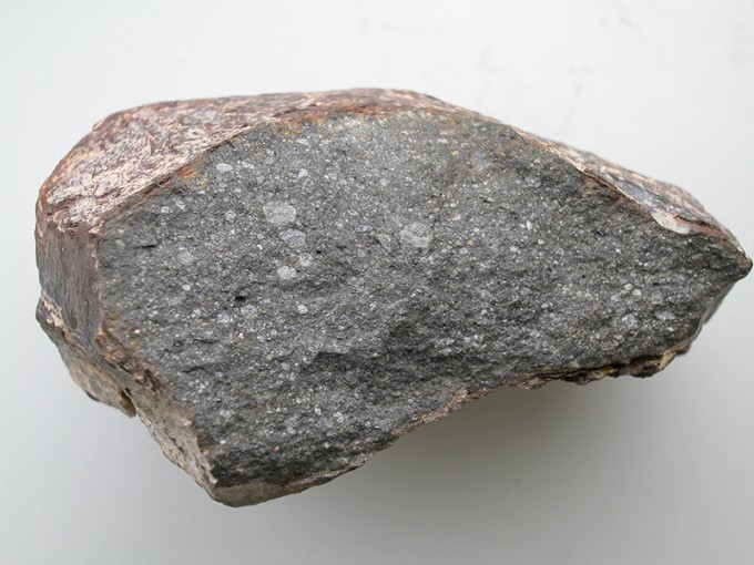 It is a Sahara 97096 meteorite, about 10 cm in size, in the French National Museum of Natural History. About 0.5% of this meteorite, an enstatite chondrite species, was found to be water. The white dots embedded in the meteorite contain hydrogen. Provided by Lorette Piani